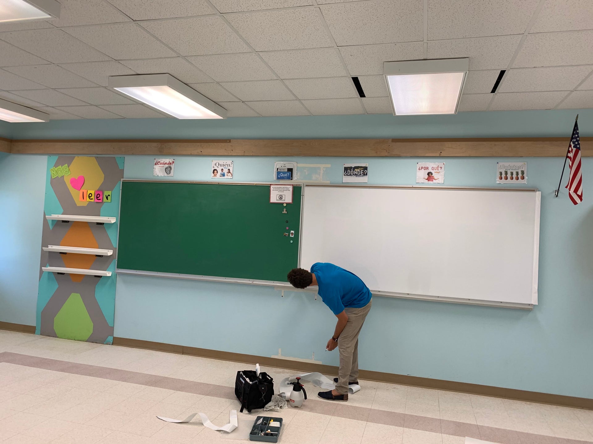 A Think Board professional inspecting a chalkboard in a classroom