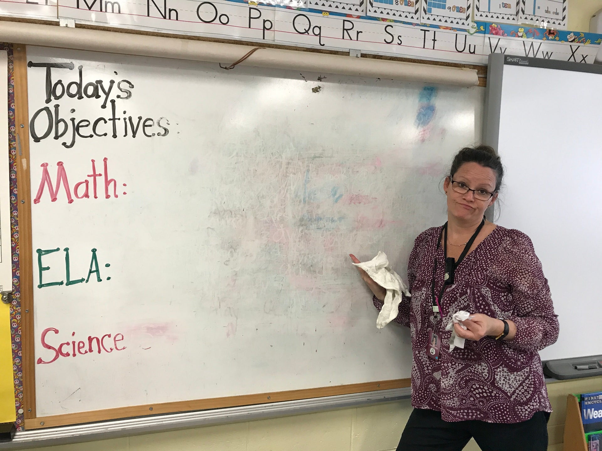 a woman standing in front of a whiteboard with ghosting